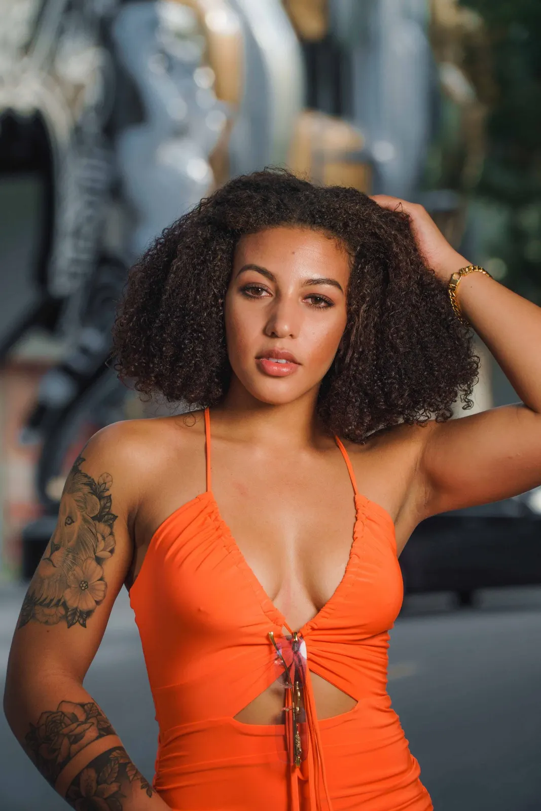 Woman in an orange dress posing in a close portrait