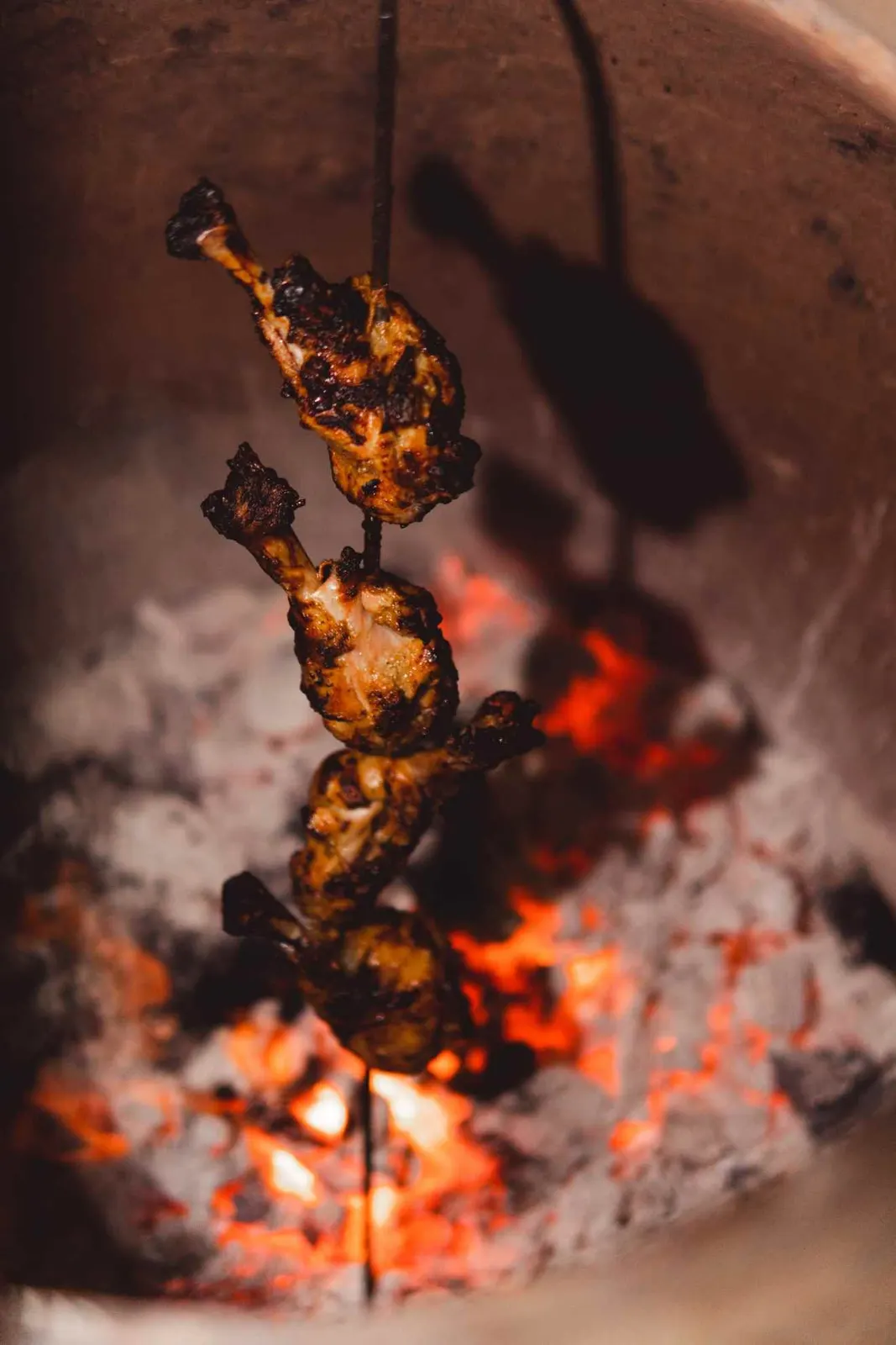 Flaming skewers cooking over a grill