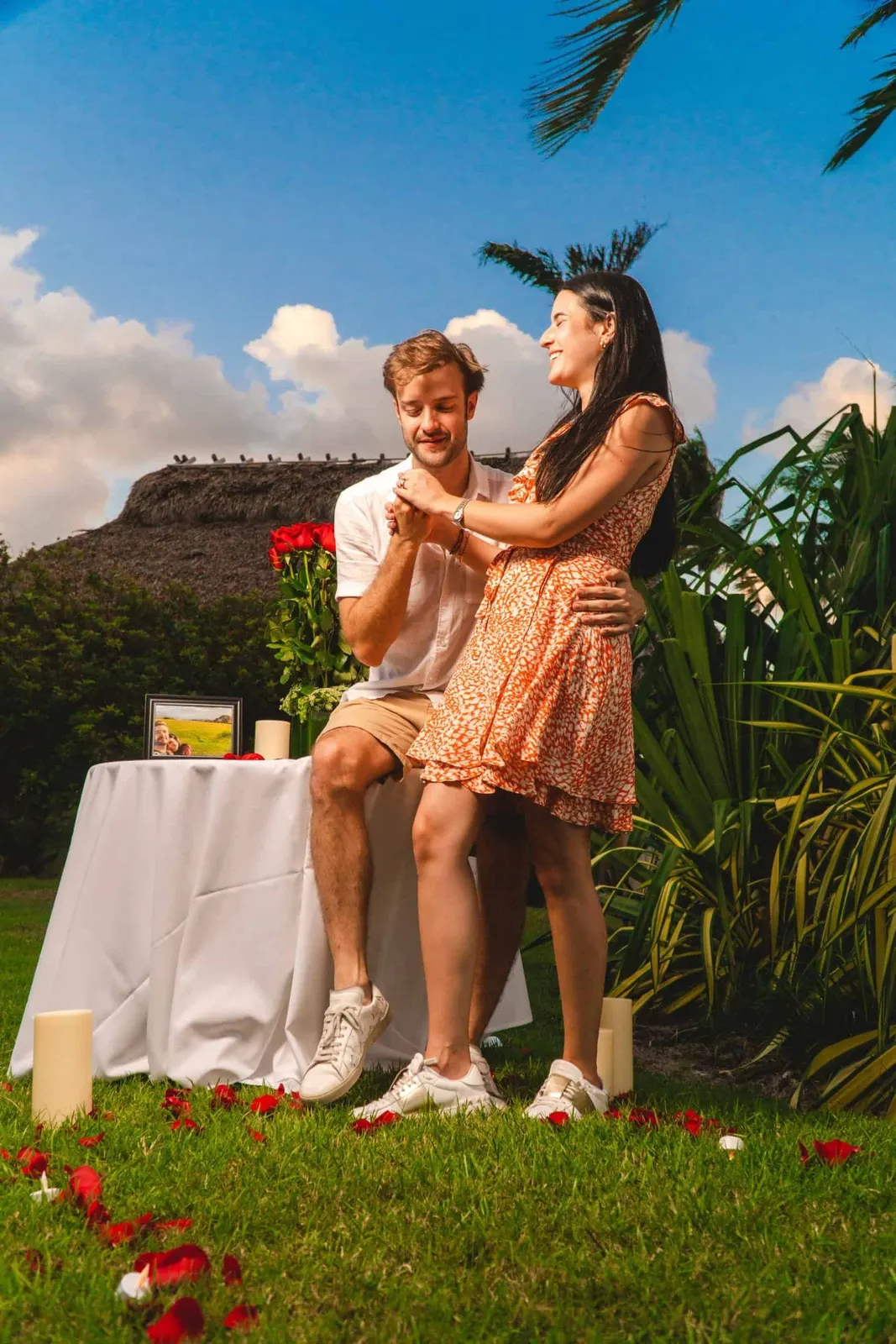 Couple seated outdoors beside a small table in a garden