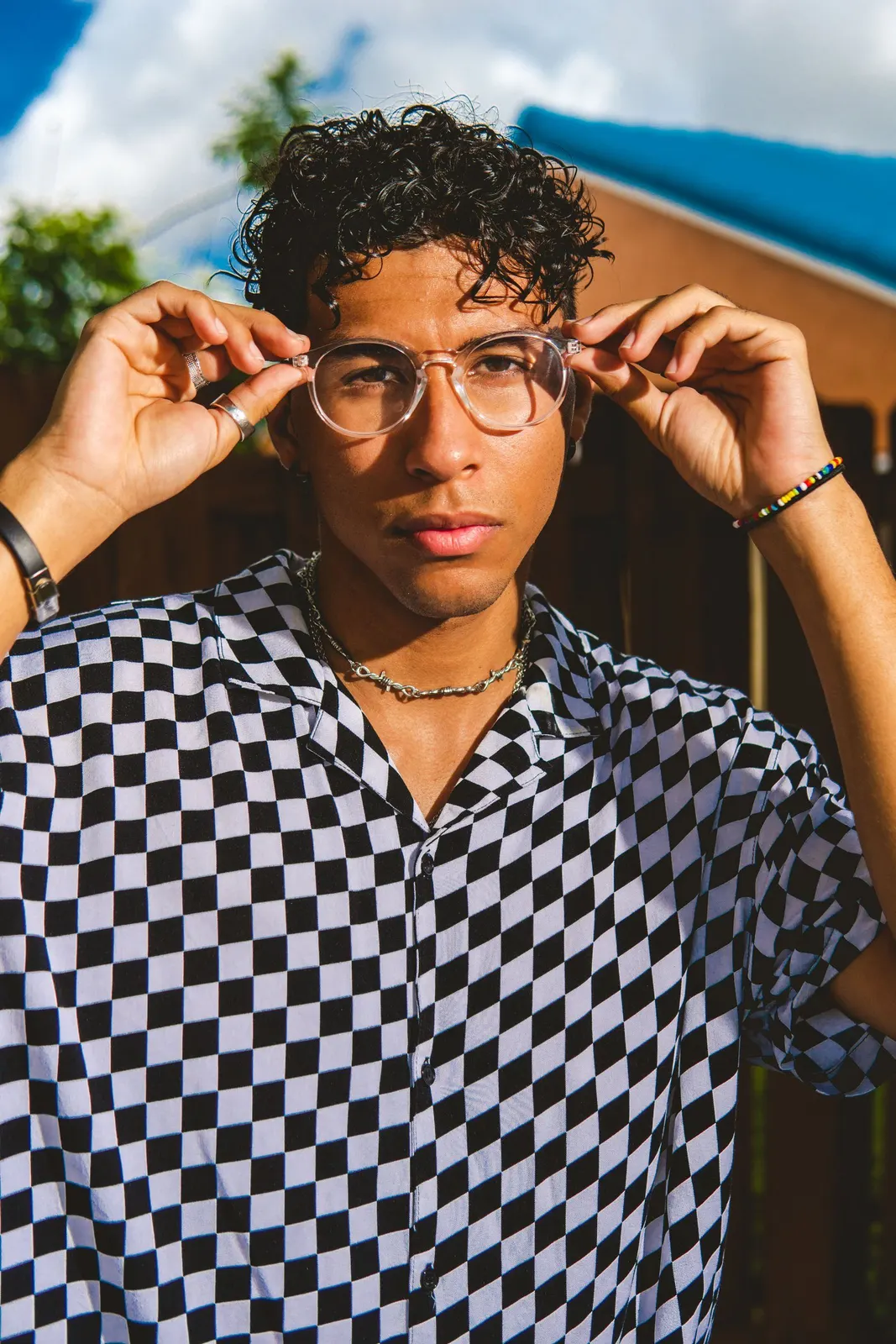 Man in glasses wearing a checked shirt outdoors