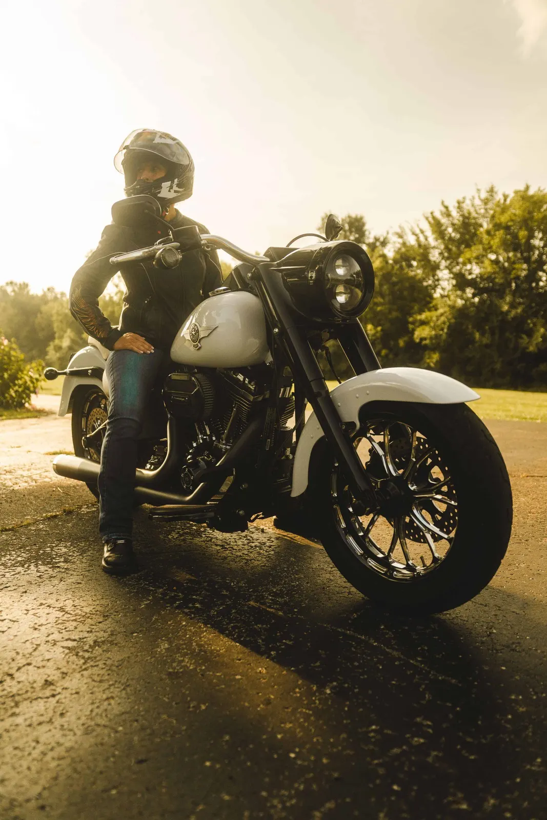 Motorcyclist seated on a motorcycle in warm evening light