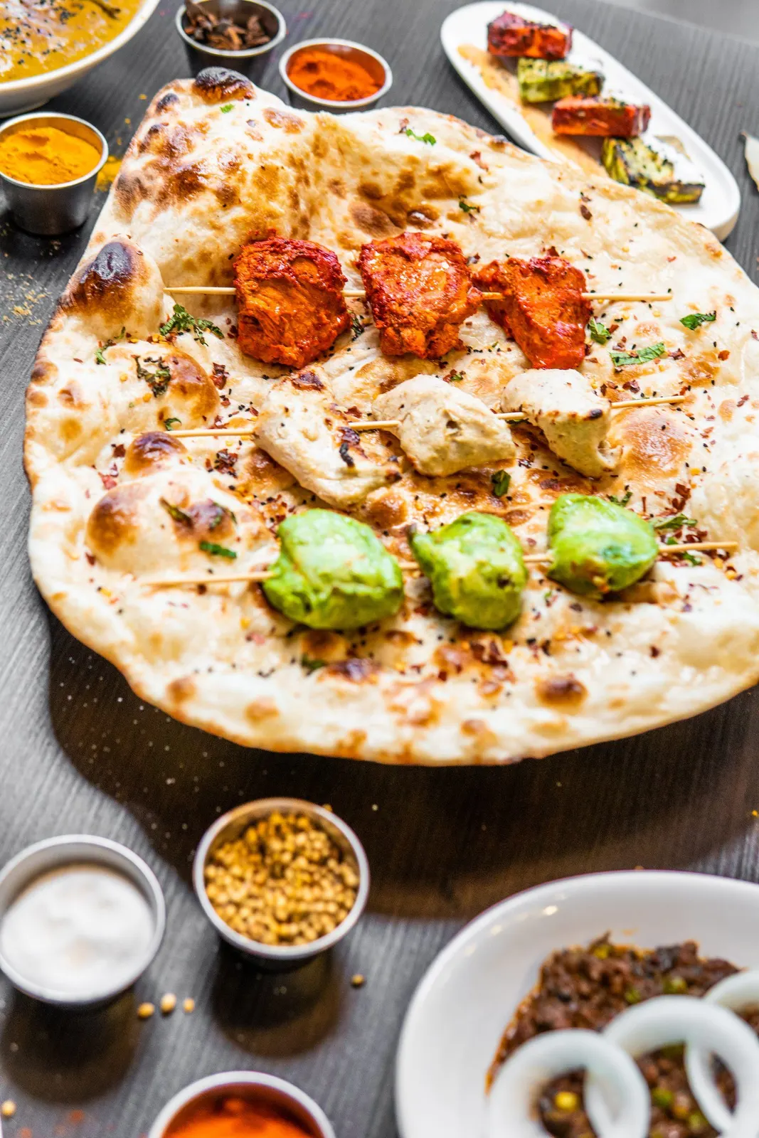 Overhead view of a flatbread with small dishes