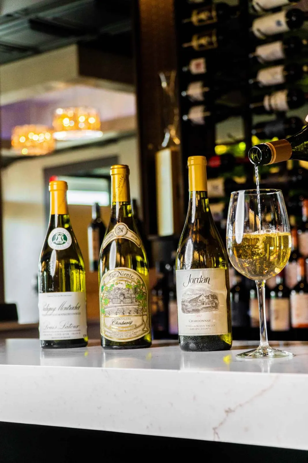 Bottles and glasses displayed on a restaurant bar
