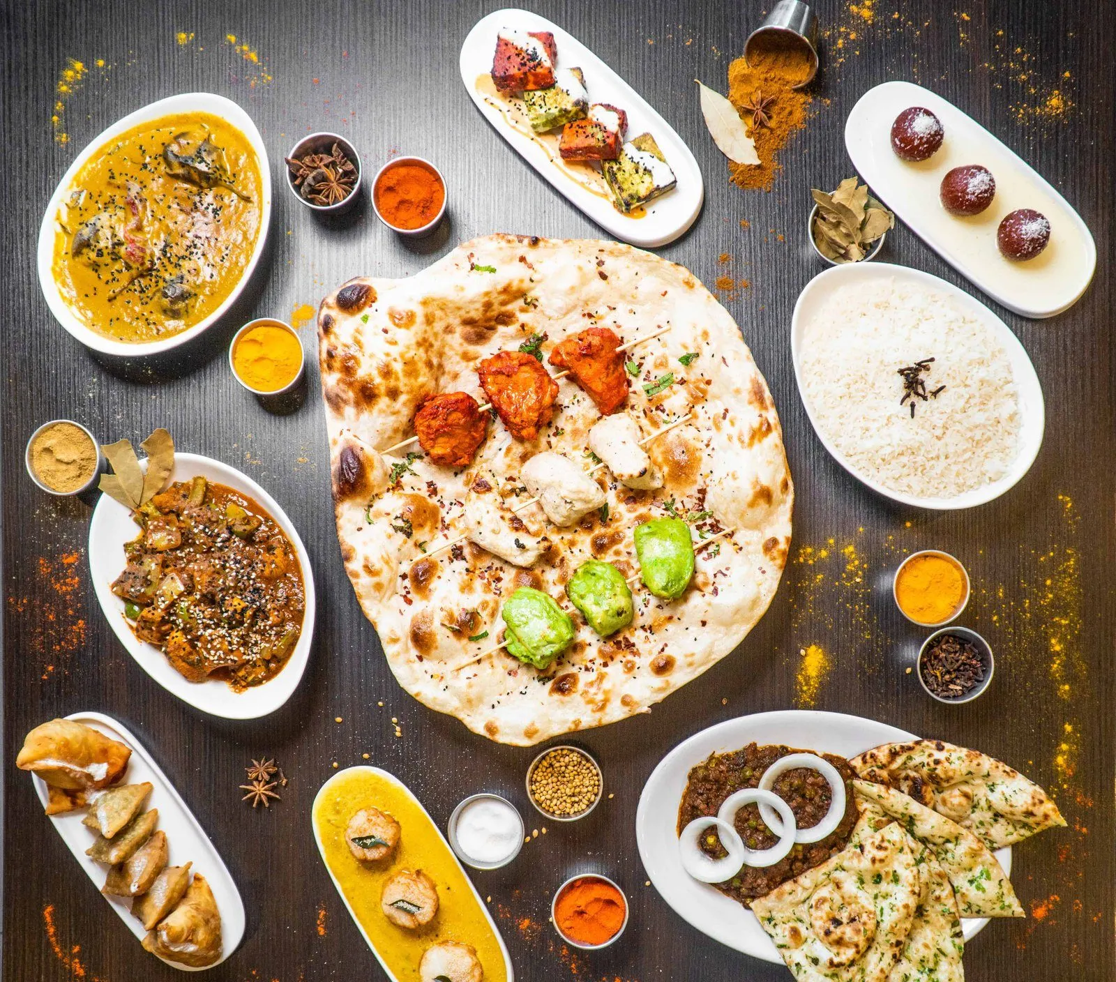 Overhead view of flatbreads and small dishes