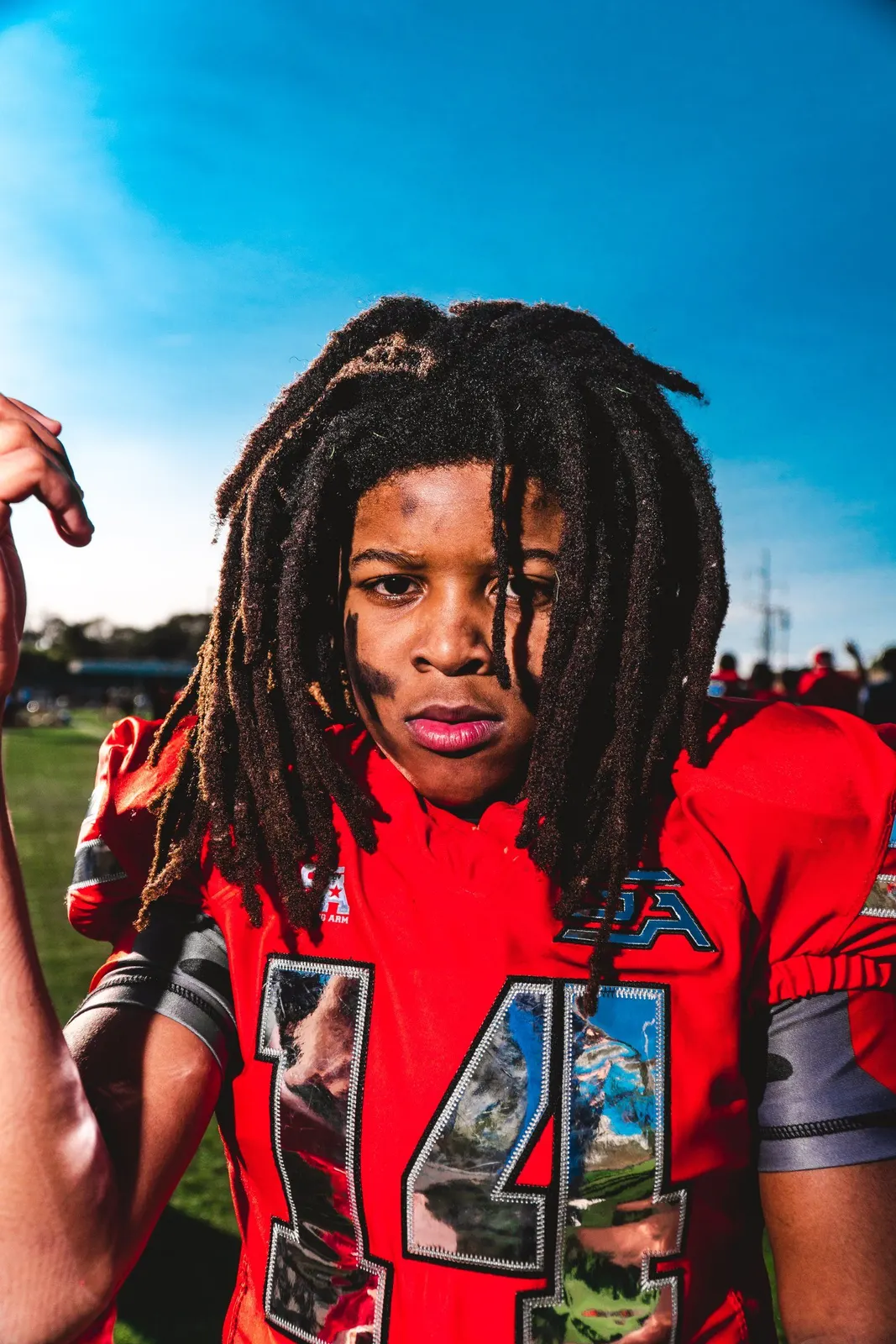 Person in a red sports jersey outdoors