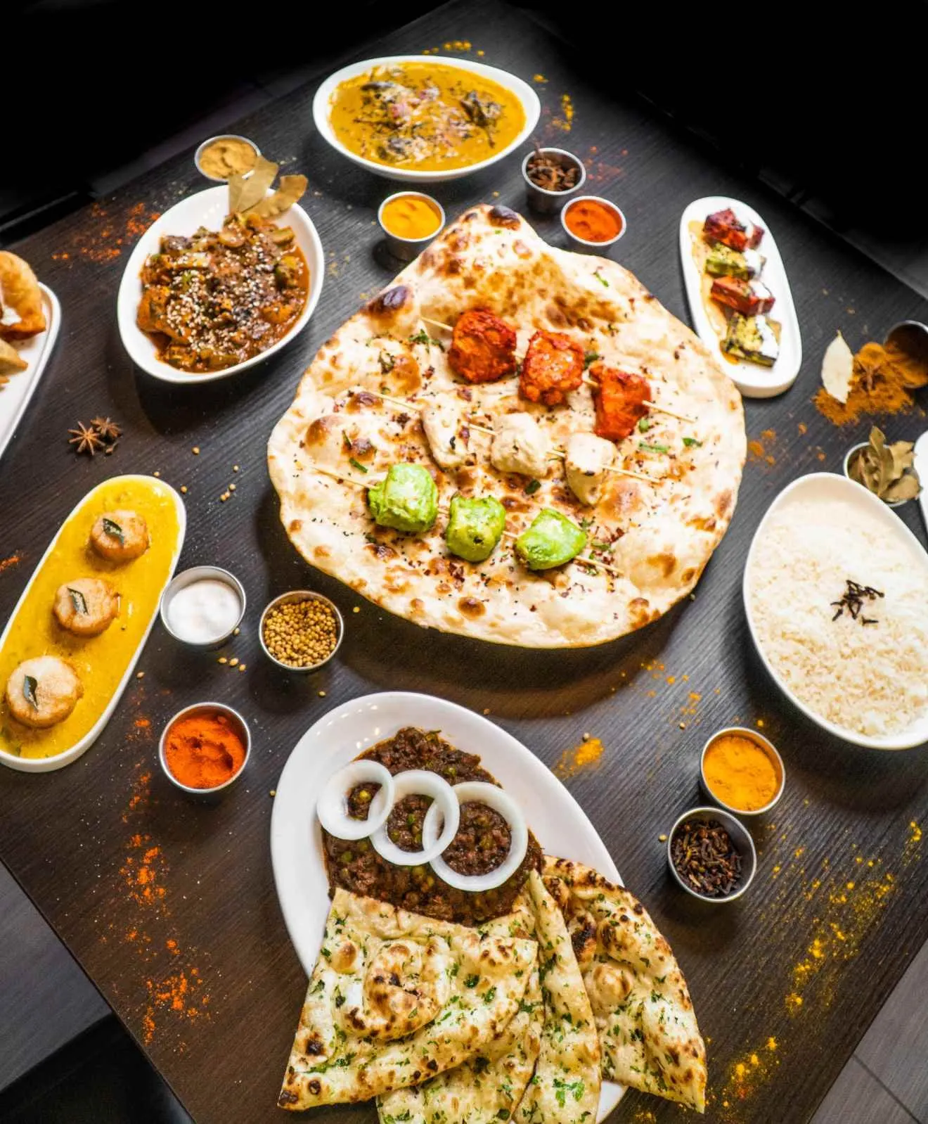 Overhead view of flatbreads and small dishes