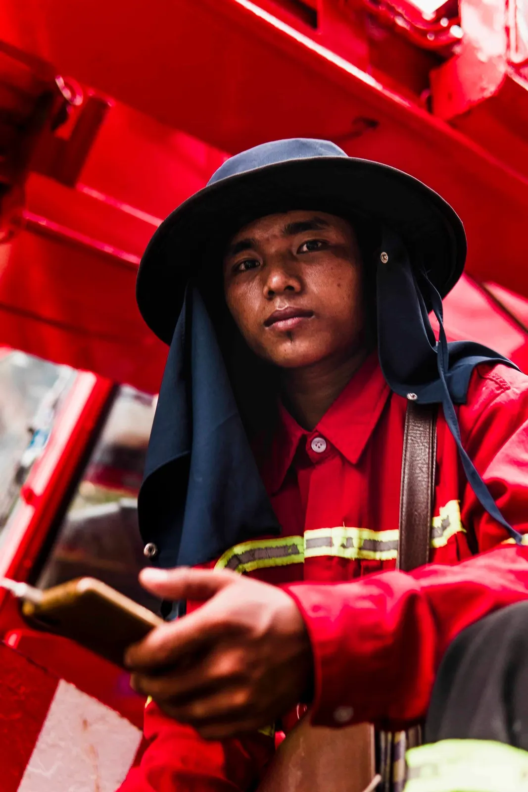 Person in red clothing and a hat in a red-lit setting