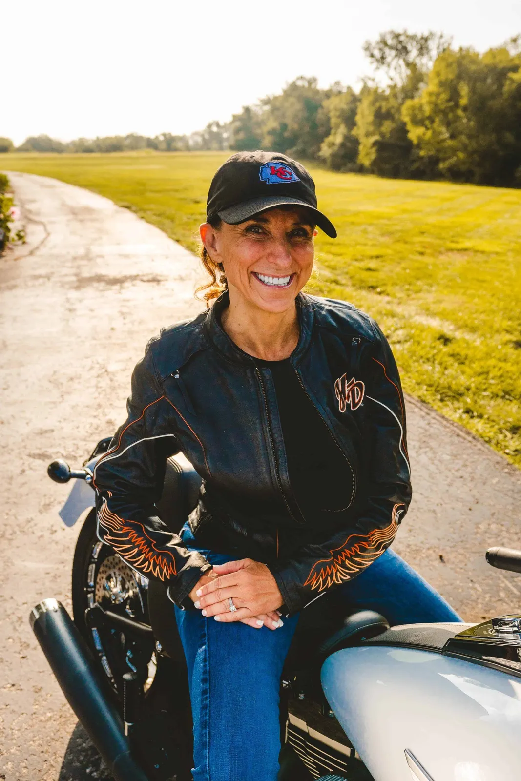 Woman seated on a motorcycle outdoors
