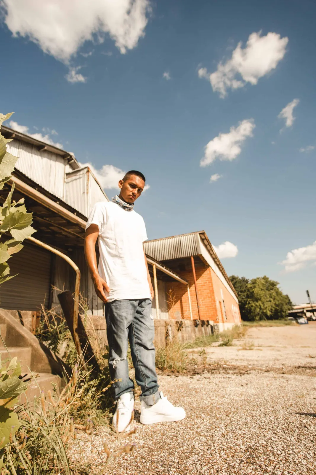Man in a white shirt walking outdoors
