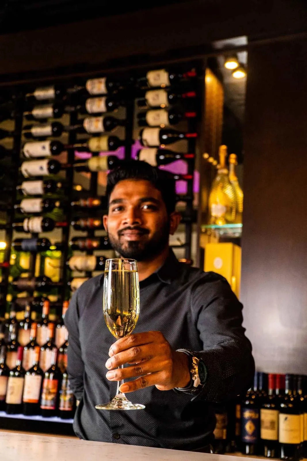 Server holding a wine glass in a restaurant